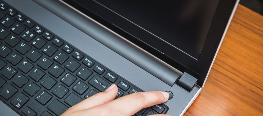 An image of someone powering down their lap top to signal that the work day is over. 
