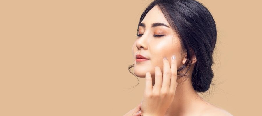 A beautiful woman in quarter profile with glowing, flawless skin.