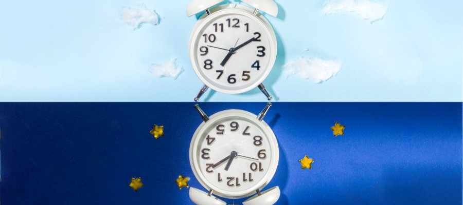 graphic of a split screen with alarm clocks on day and night backgrounds.