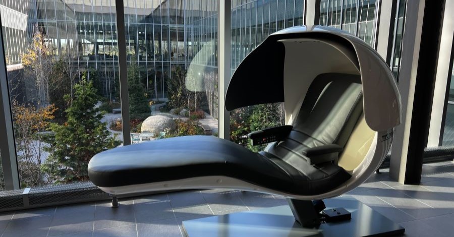 MetroNaps EnergyPod by a large window in an office building.