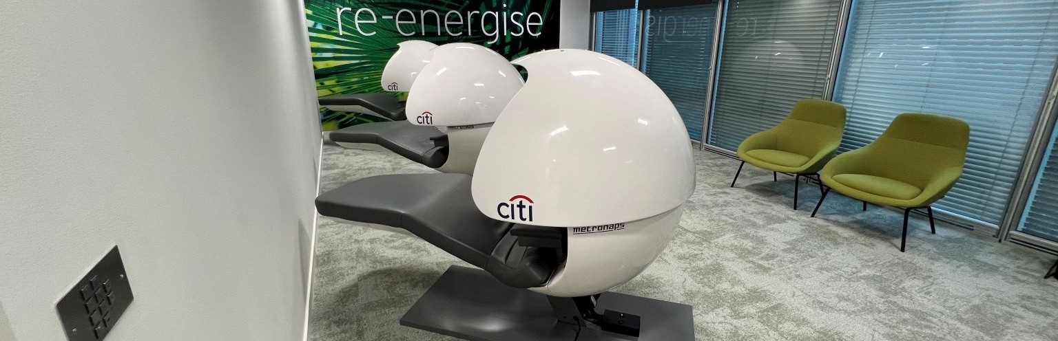 3 MetroNaps EnergyPods are in a room that has the words "re-energise" against the back wall.